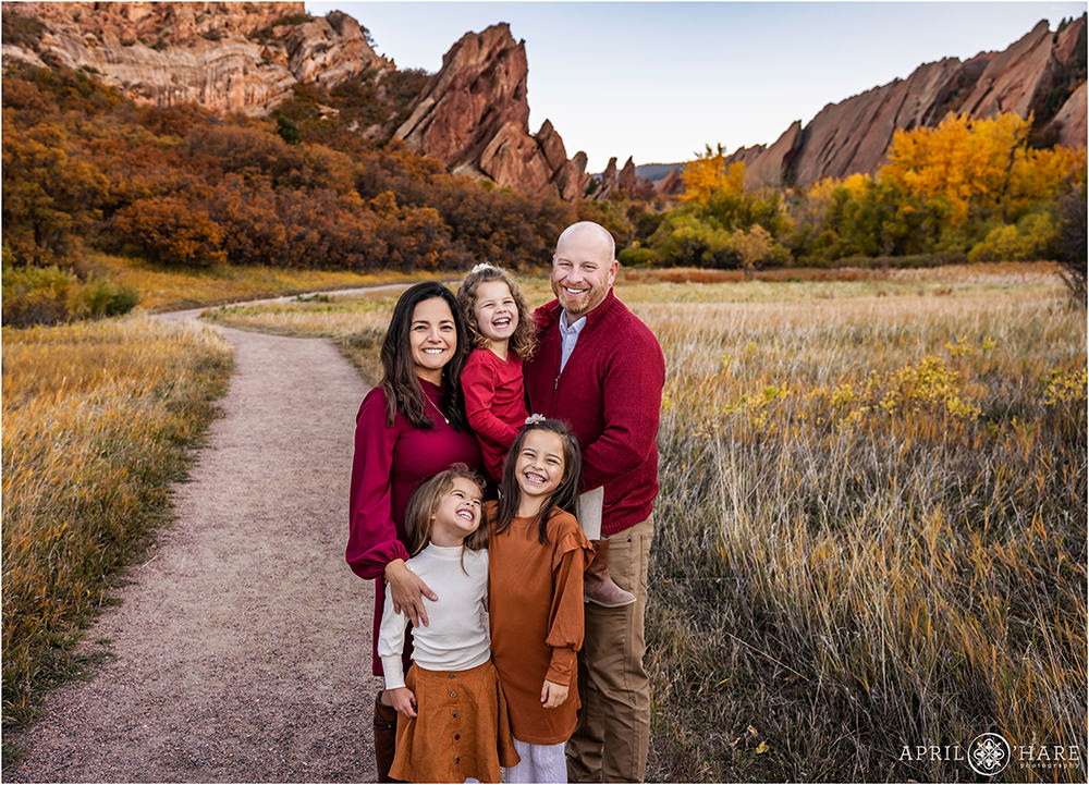 Adorable family photos with 3 young girls laughing in the pretty fall color scenery of Roxborough State Park