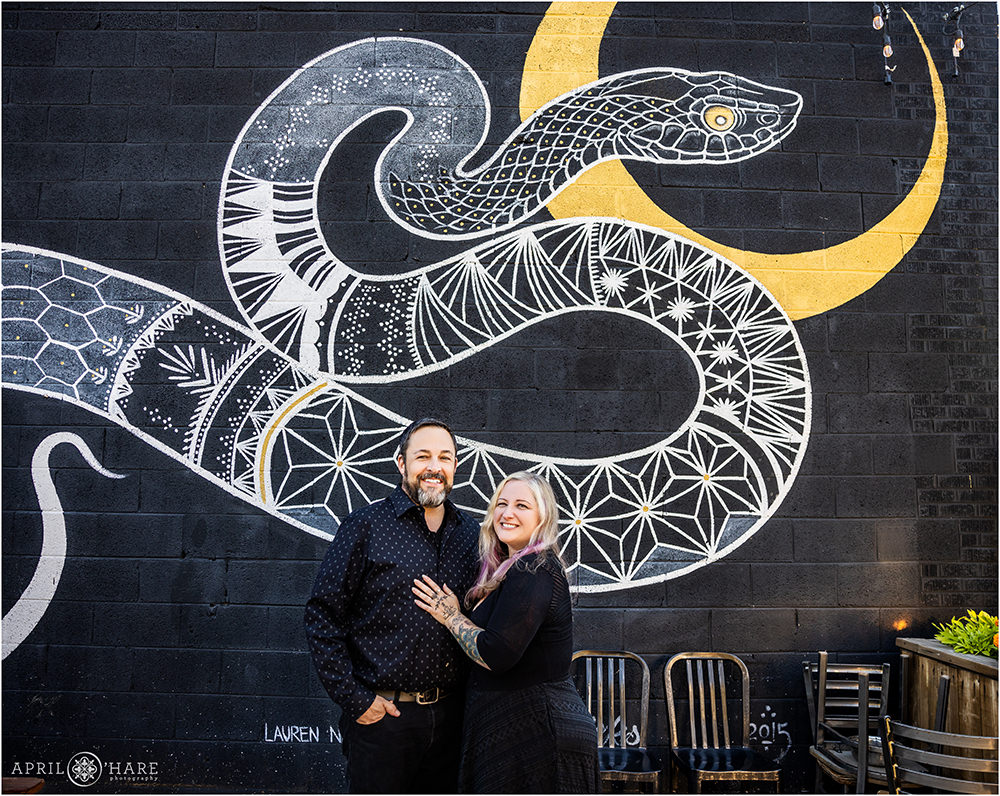 Couples Portrait with the Snake Mural on a Black wall at Gold Point in North Denver