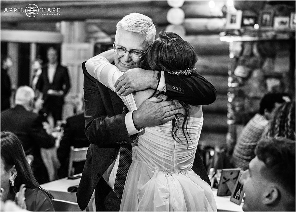 Bride hugs her father in law on her wedding day at the Evergreen Lake House