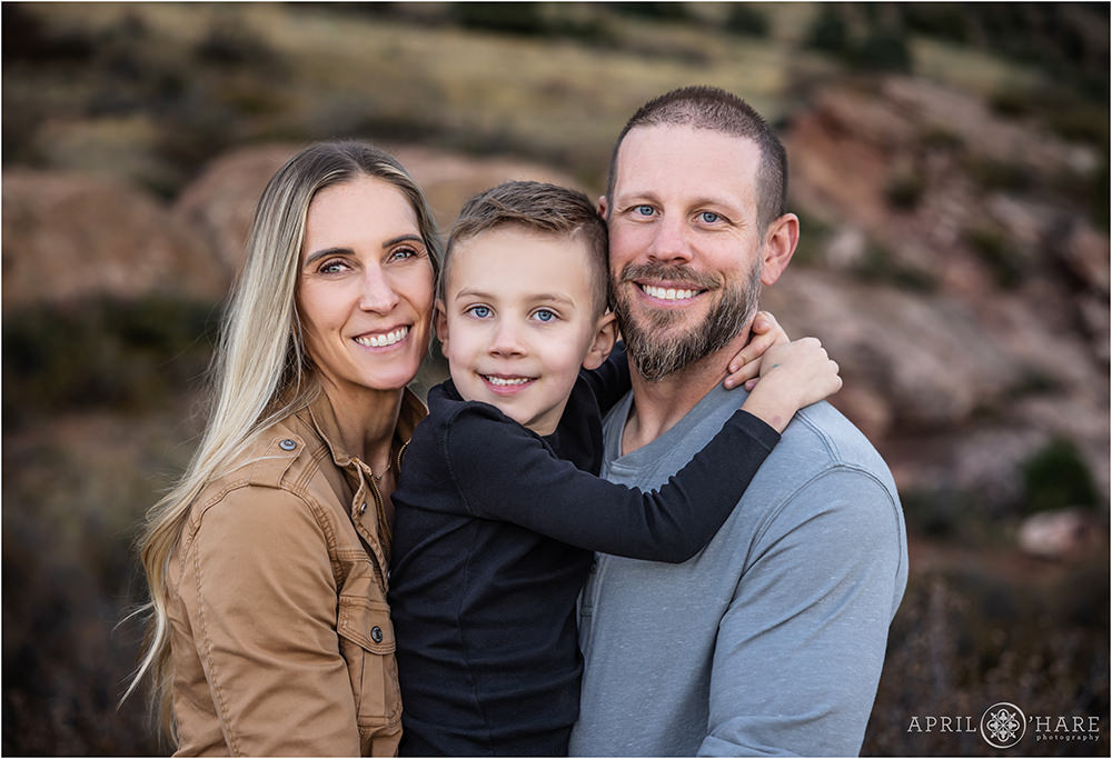 Close up photo of a family of three at East Mount Falcon Trail in Morrison Colorado