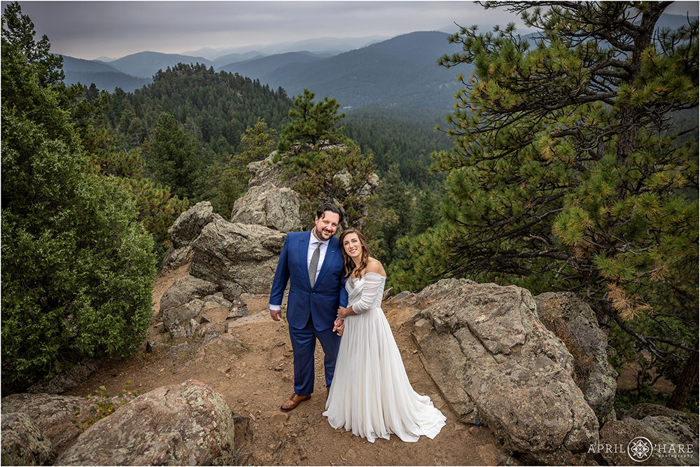 Pretty portrait of a wedding couple standing in gorgeous mountain scenery at West Mount Falcon Trailhead in Colorado