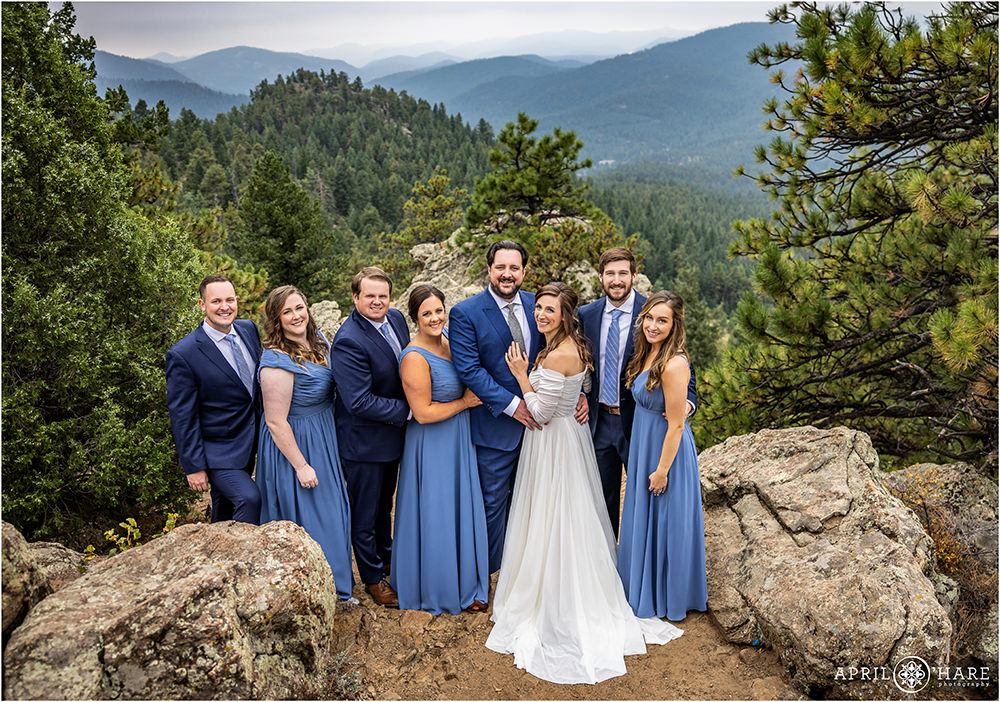 Wedding party portrait in pretty Colorado scenery with mountain backdrop at West Mount Falcon Trailhead