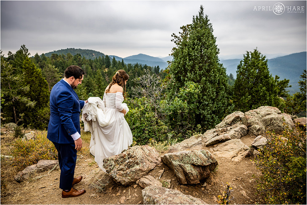 Wedding couple walk to their portraits at West Mount Falcon Trailhead