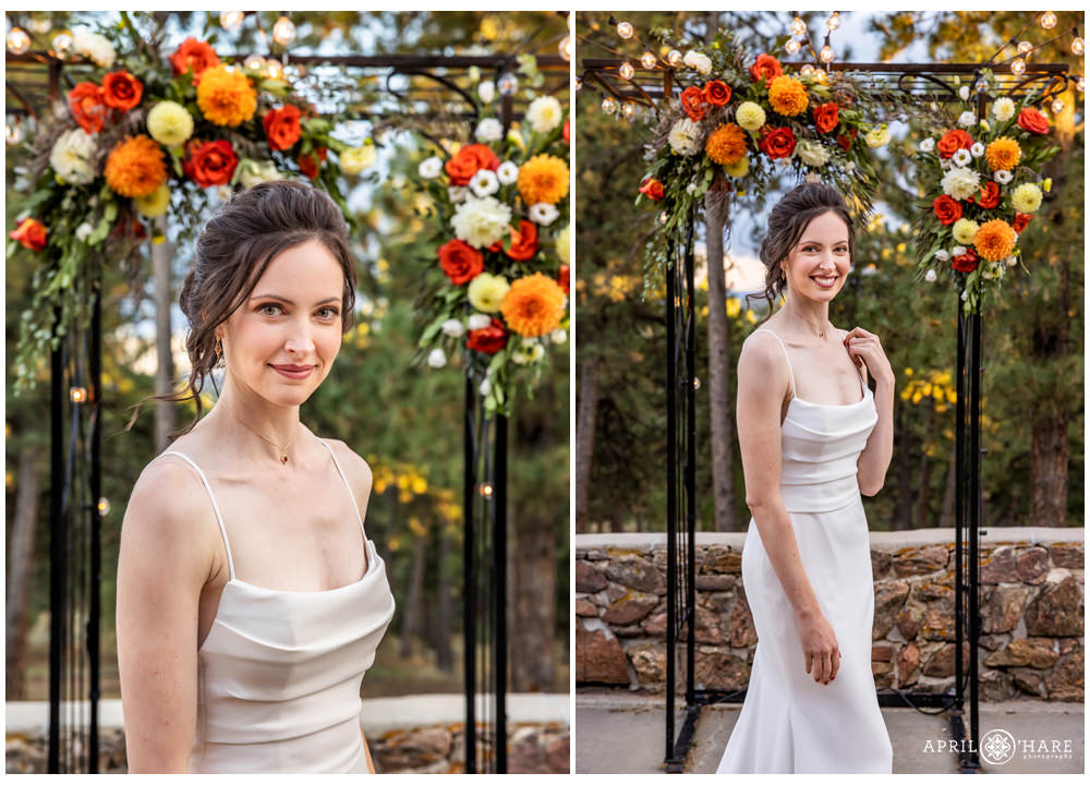 Beautiful warm florals in shades of red and orange frame a beautiful brunette bride on her wedding day at Boettcher Mansion in Golden Colorado