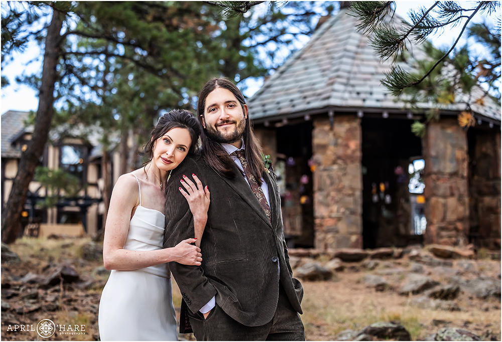 Gorgeous classic wedding portrait with the stone gazebo in the backdrop at Bottcher Mansion in Colorado