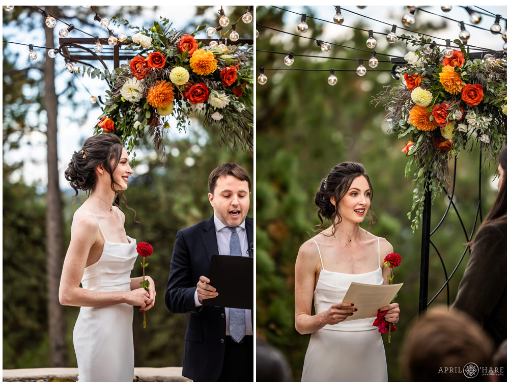Bride says her vows under an orange floral display on the outside patio at Boettcher Mansion in Colorado