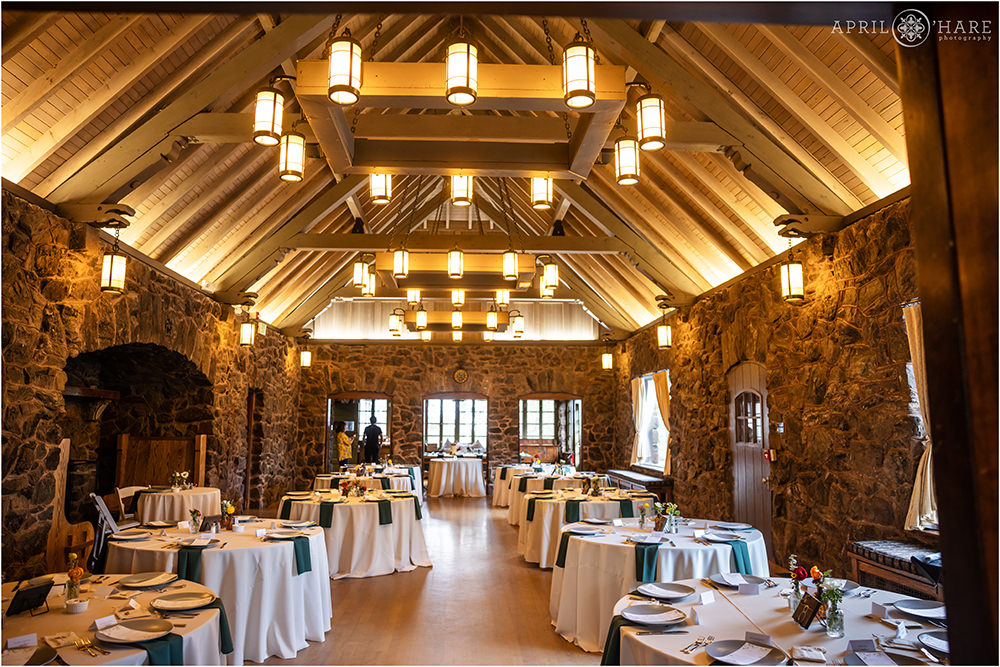 Interior of the Fireside Room set up for a wedding reception dinner at Boettcher Mansion in Colorado