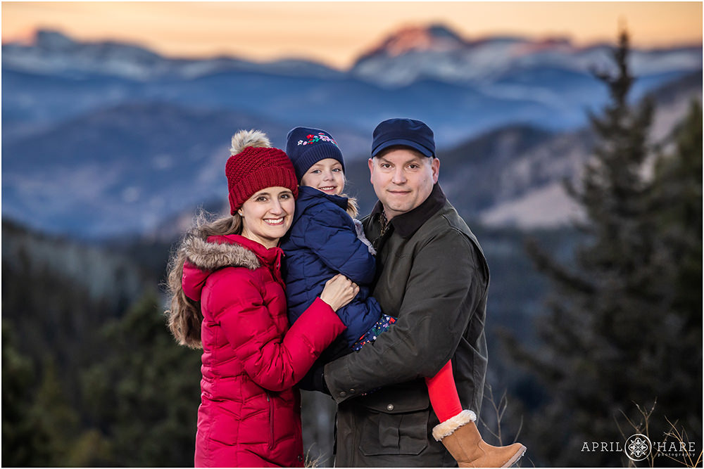 Sweet family portrait with a mountain backdrop in Colorado at Sunset