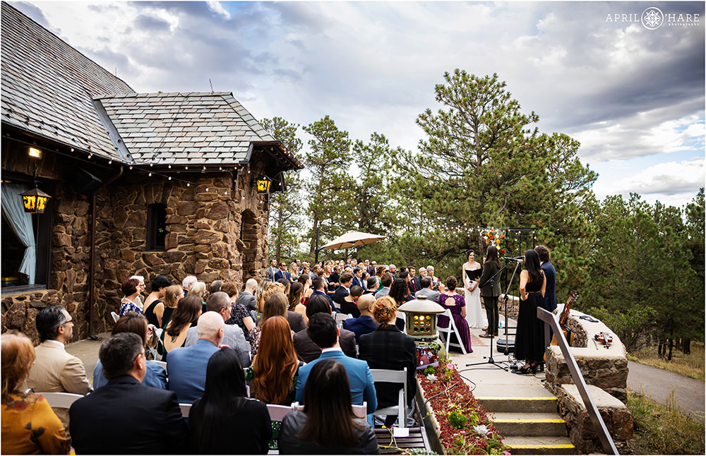 Wide angle view of a wedding ceremony on the patio at Boettcher Mansion in Colorado