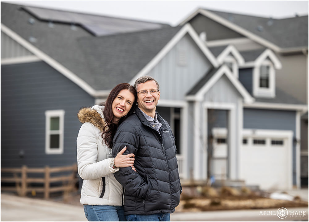Cute couples portrait in front of their new home in Littleton Colorado