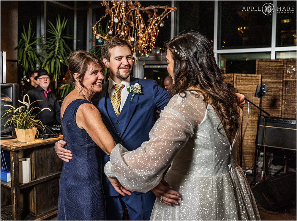 Groom and his mom bring bride into their embrace at Coohills in Denver CO