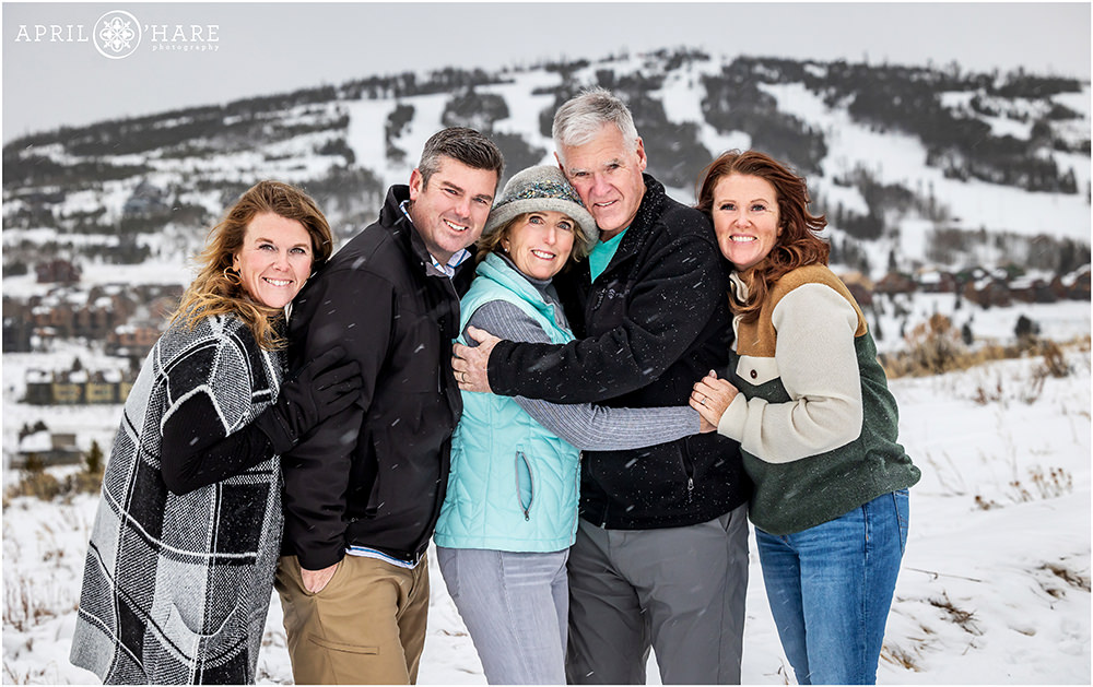 Mom and Dad with their grown up adult children get a family portrait in Granby Colorado