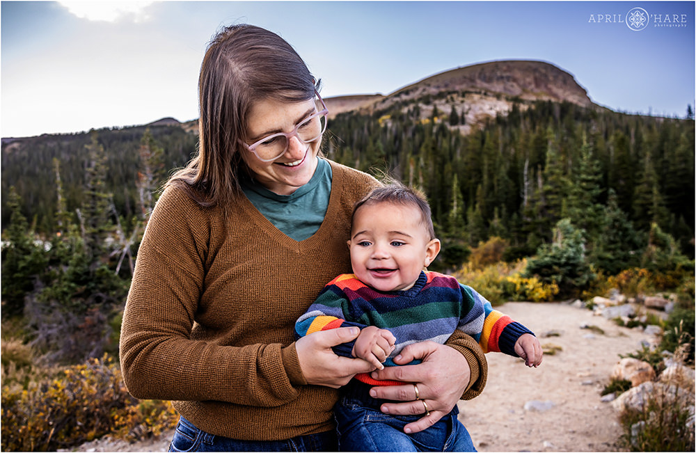 A mama holds her young baby son in the Indian Peaks Wilderness area near Ward, CO