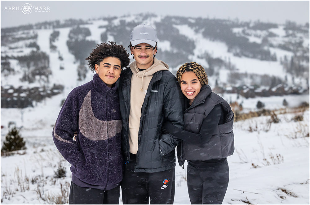 Three siblings pose for a photo together at Granby Ski Resort in Colorado