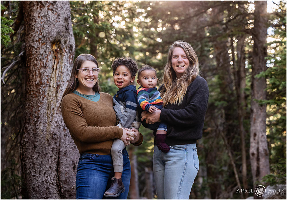 Family of Four in the woods with their two young sons at Indian Peaks Wilderness Area in Colorado