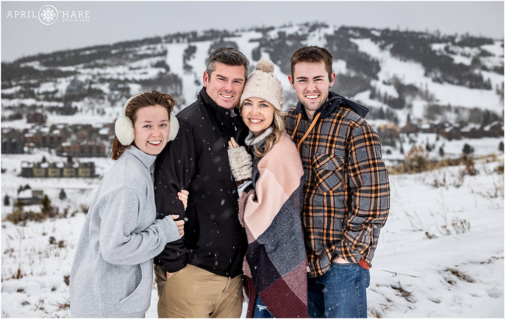 Adorable family of four get a portrait together with Granby Ski Resort in the backdrop