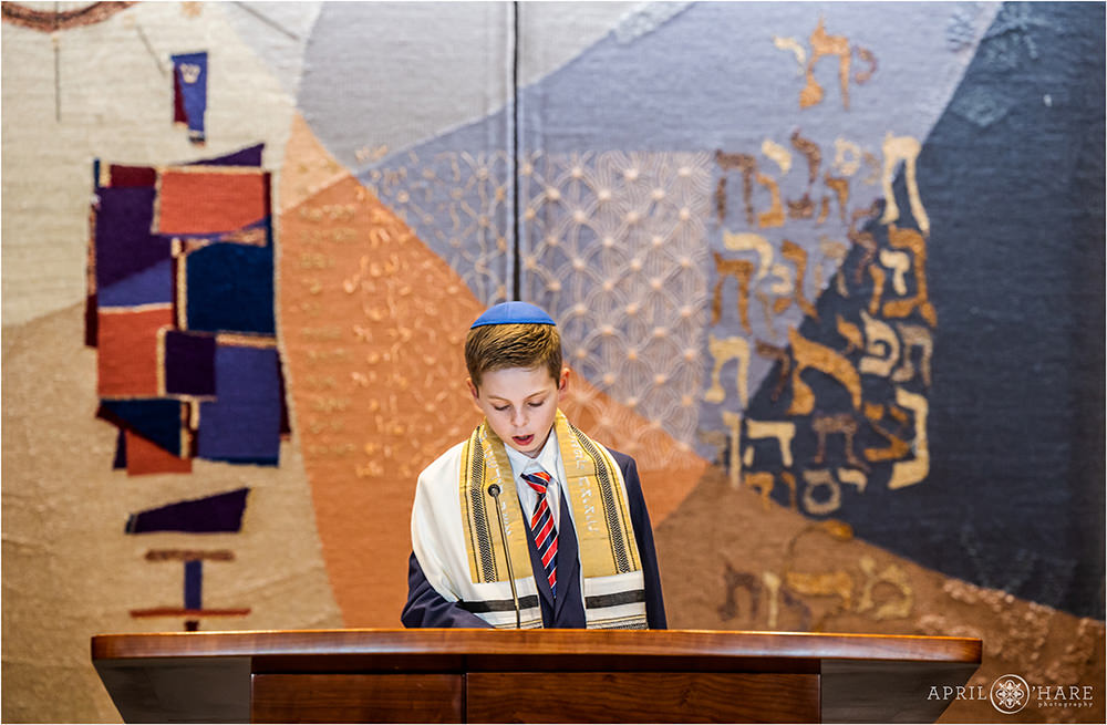 Bar Mitzvah boy reads aloud during his rehearsal at Temple Sinai in Denver CO