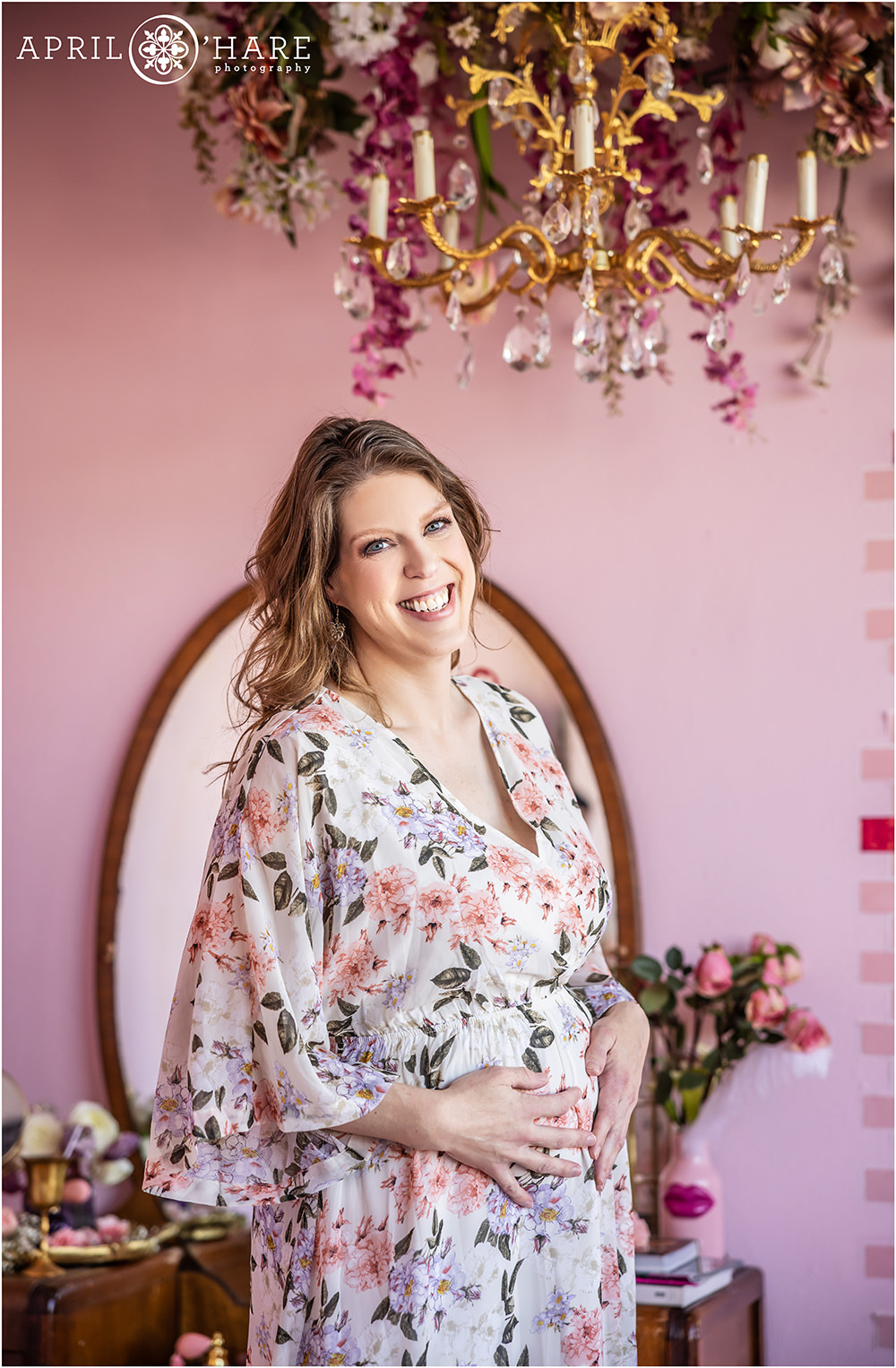 Gorgeous floral maternity portrait for a pregnant mama to be in a pretty pink Valentine's Day themed styled set in a Denver photography studio