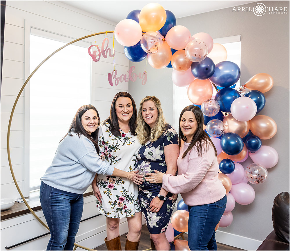 Denver Baby Shower Photographer photographs a pregnant woman with her wife and sister in laws at her baby shower in Littleton CO