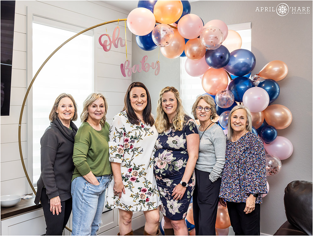 Family photos in front of the cute baby shower balloon arch with pink and blue balloons