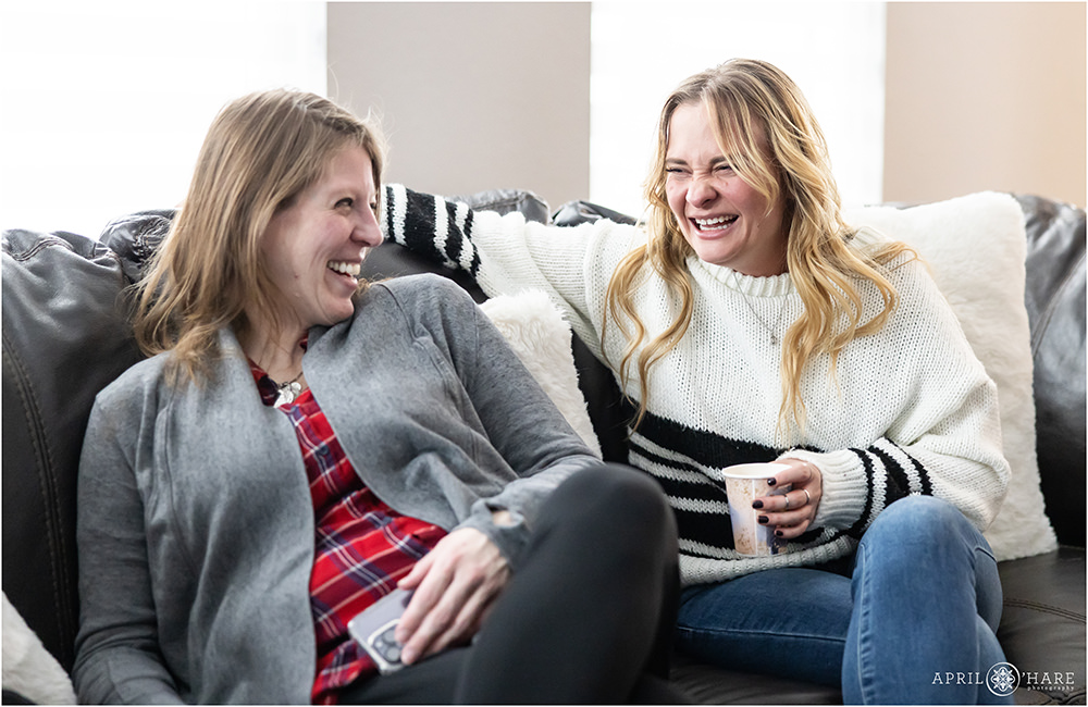 Candid photos of friends laughing together at a baby shower in Colorado