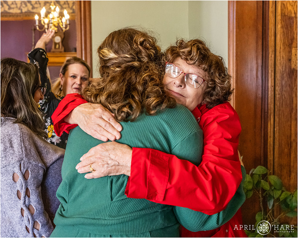 Guests hug the Mama to be at her Denver Baby Shower at the Lumber Baron Inn
