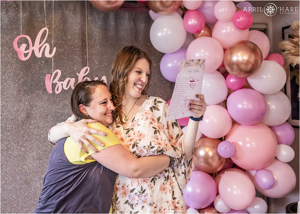 Sweet moment of a woman with an old friend at her baby shower in Denver