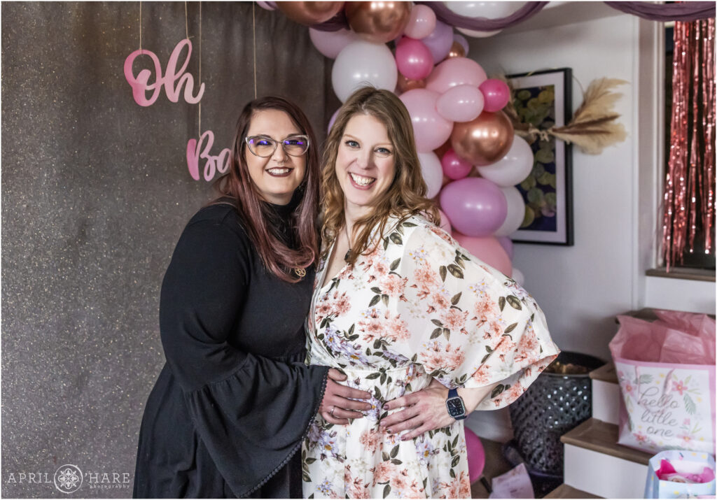 Friends pose for a photo together at her baby shower in Denver
