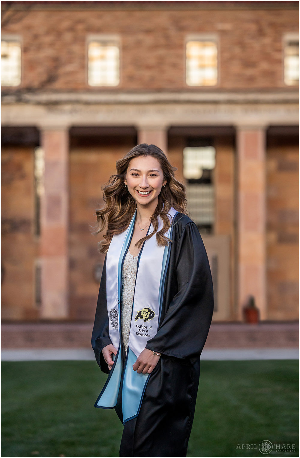 Graduation Photography Session with Gown in front of the Norlin library at CU Boulder Campus
