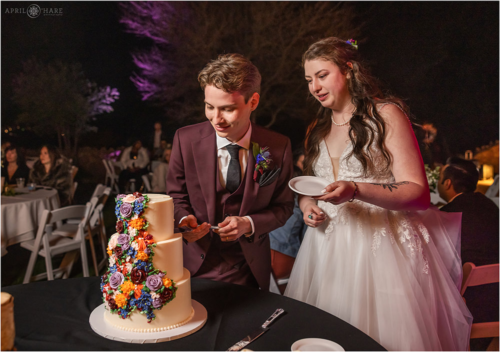 Bride and groom cut their cake at Red Rocks Trading Post Backyard wedding reception