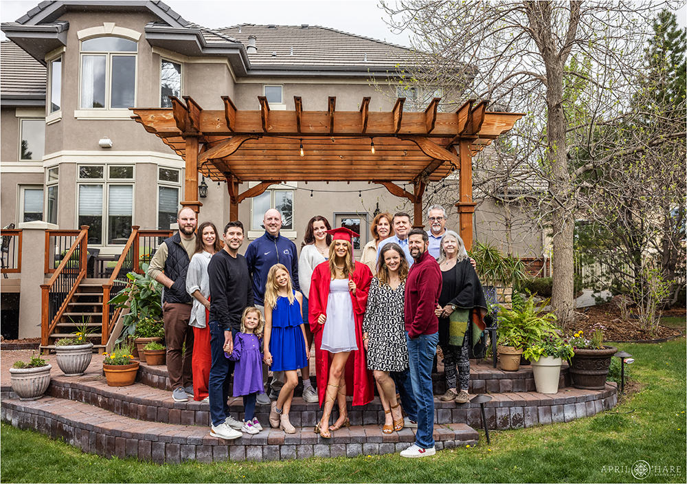 High school graduate poses for a sweet photo with her extended family at home in Colorado