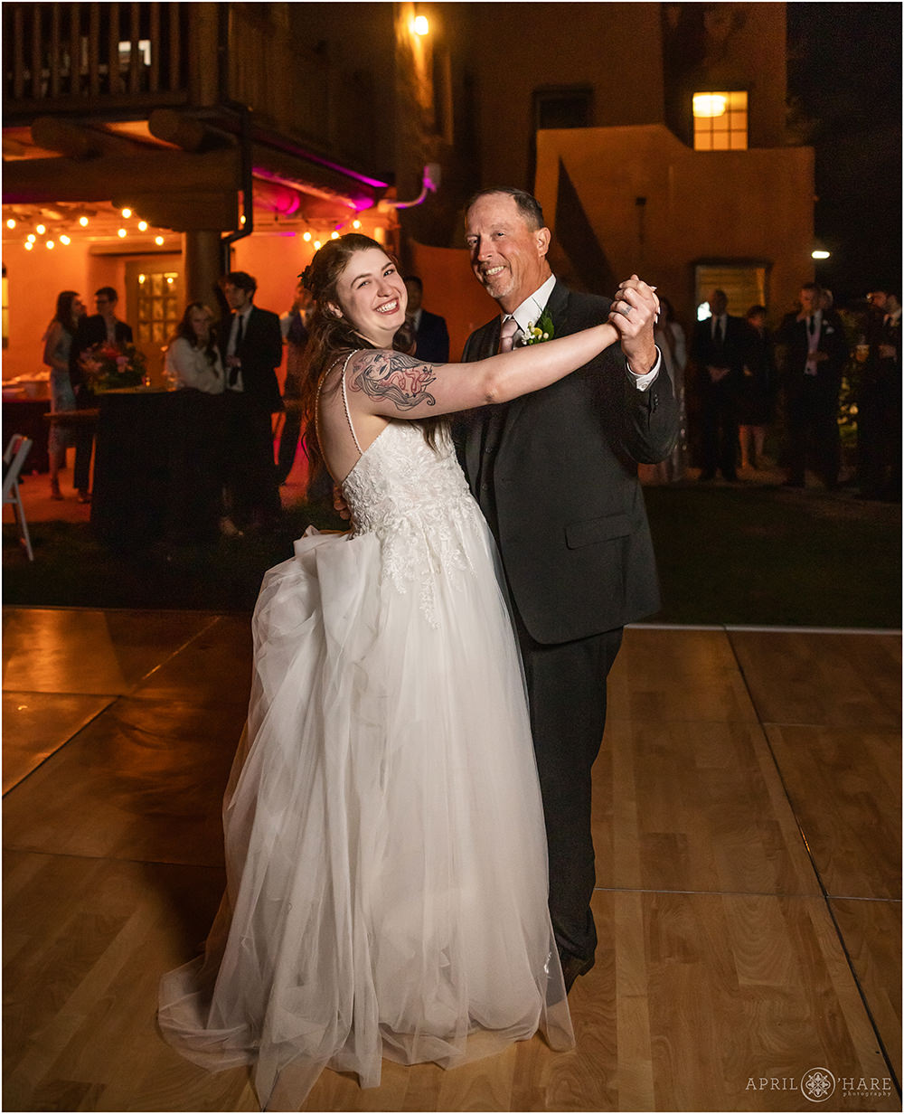 Bride dances with her dad on her wedding day at Red Rocks Trading Post