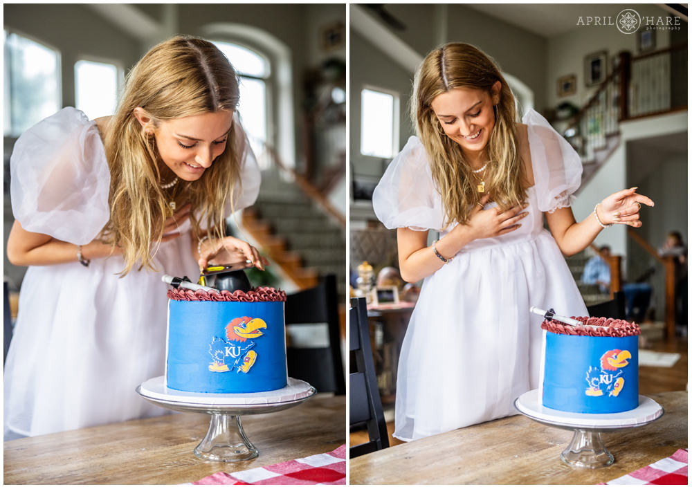 High school grad wearing a pretty white dress looks at the cake her family got for her to celebrate her graduation