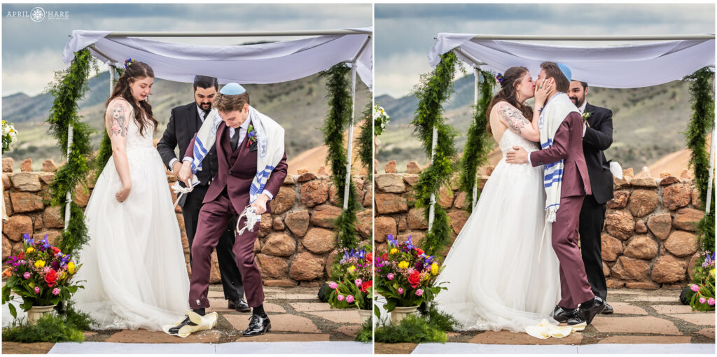 Groom steps on glass and kisses his bride at their outdoor Jewish wedding at Red Rocks