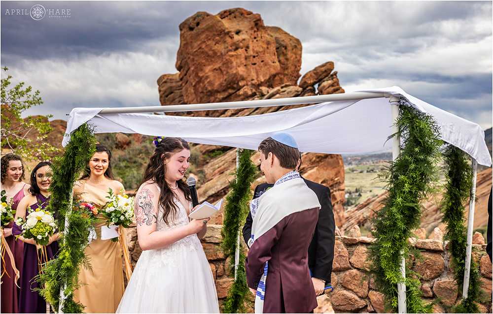 Bride says her vows under the huppah at Red Rocks in Colorado