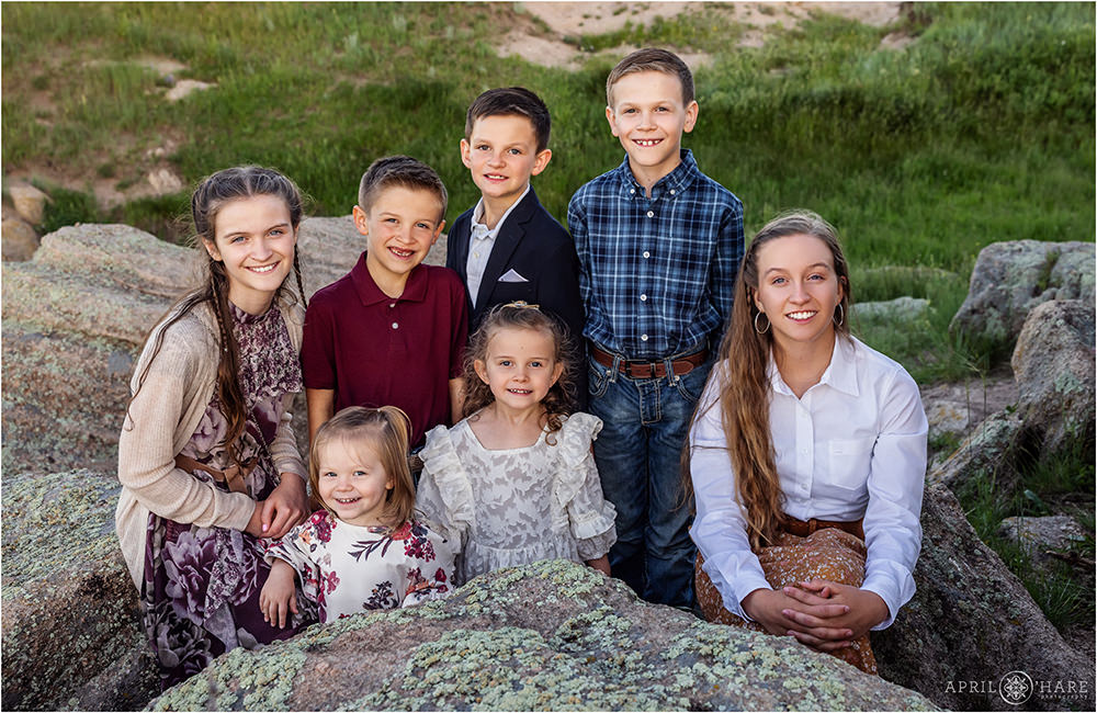 Seven brothers and sisters pose on the rocks at their family farm in Franktown Colorado