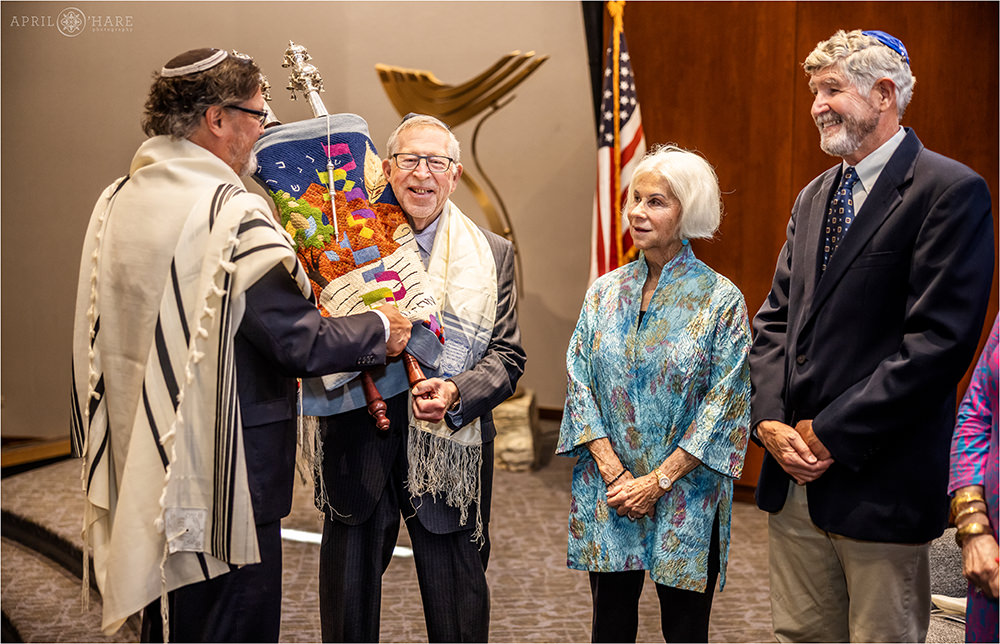 Grandfather of Bar mitzvah boy holds the Torah at Temple Sinai