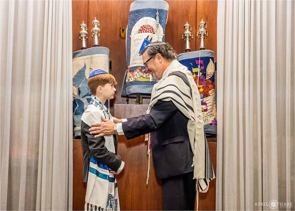 Rabbi speaks to a young man on the day of his bar mitzvah rehearsal at Temple Sinai in Denver