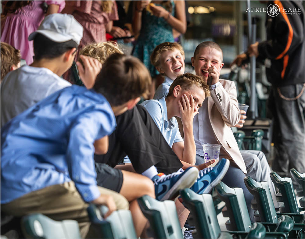 Kids laugh as they enjoy sitting in the stands at Coors Field at a Bar Mitzvah party