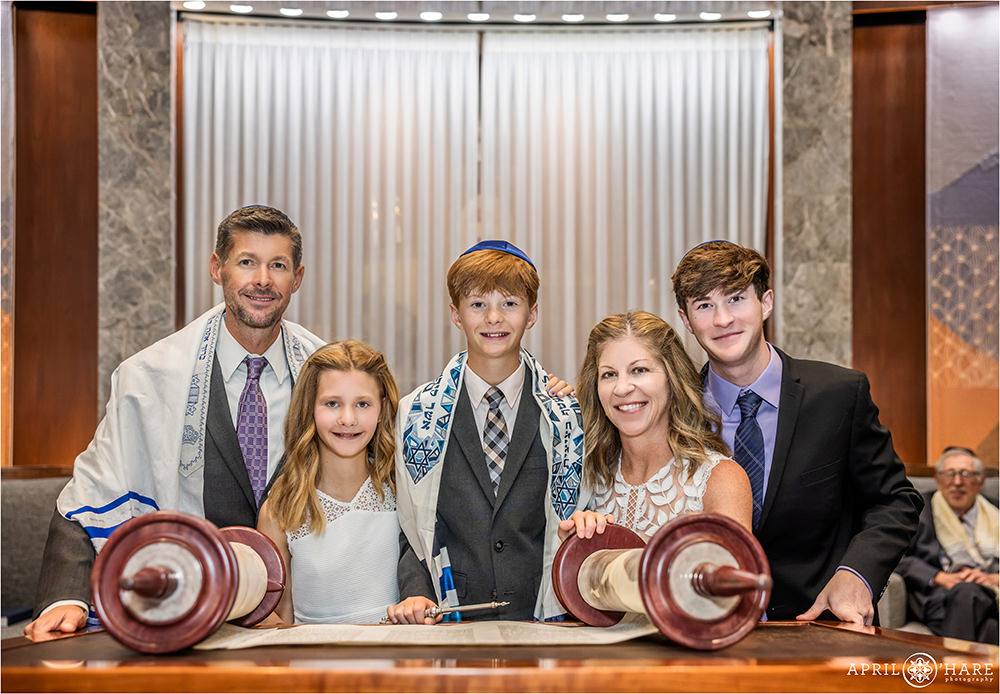 Family gathered around the Torah for a portrait at Temple Sinai in Denver CO