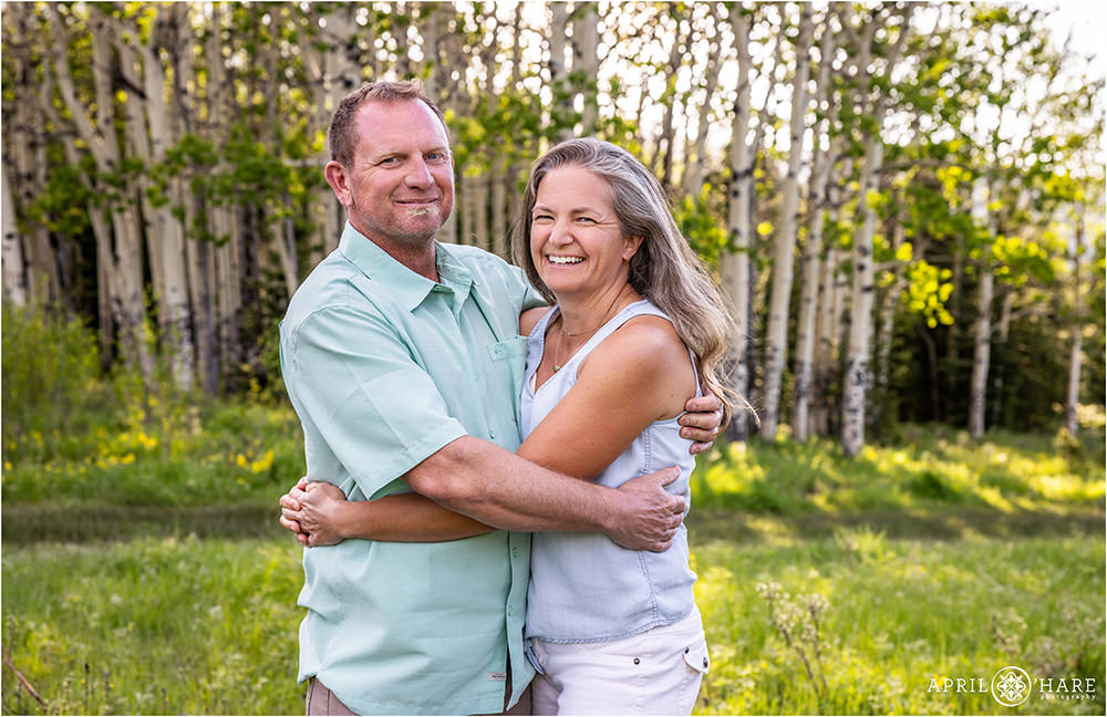 Cute couples photo with Aspen Tree backdrop in Evergreen CO