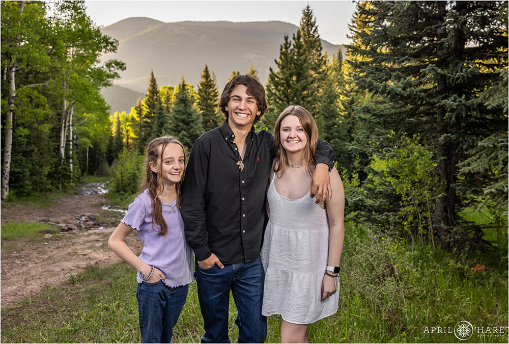 Three cousins with mountain backdrop in Evergreen Colorado