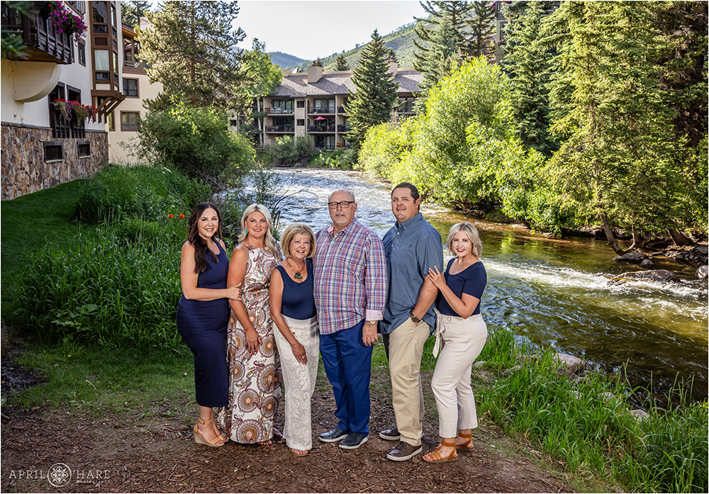 Parents with their adult children next to Gore Creek at Vail Village in Colorado
