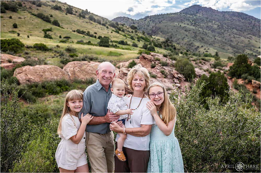Red Rocks Backdrop for Grandparents with their Grandkids photo during a family photoshoot in Colorado