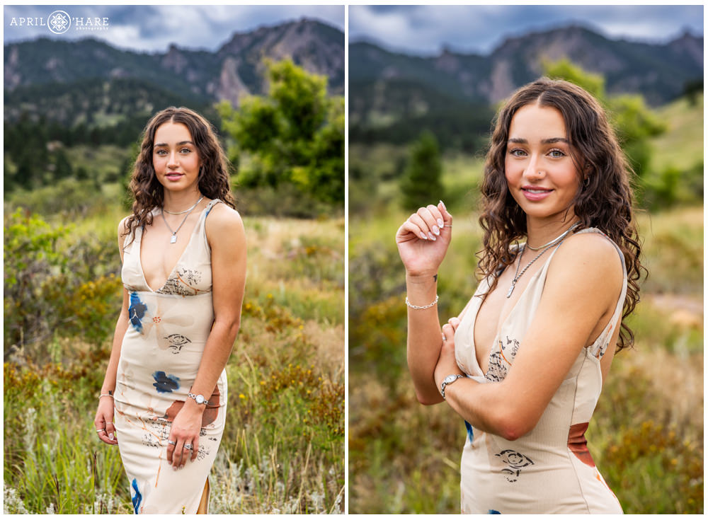 High school senior girl with curly hair poses in the beautiful mountain scenery of South Mesa Trail in Boulder CO