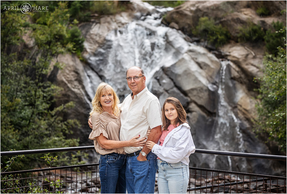 Family photo during summer in front of Helen Hunt Falls waterfall in Colorado Springs