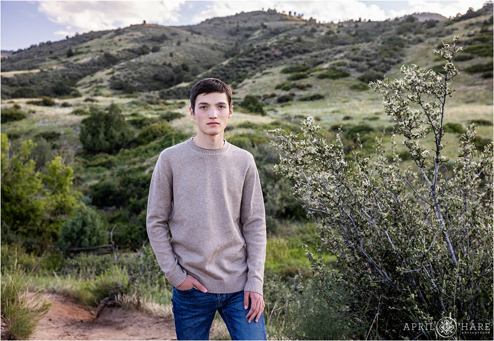 Morrison Trailhead senior portrait for a young man with a serious look on his face during summer in Colorado