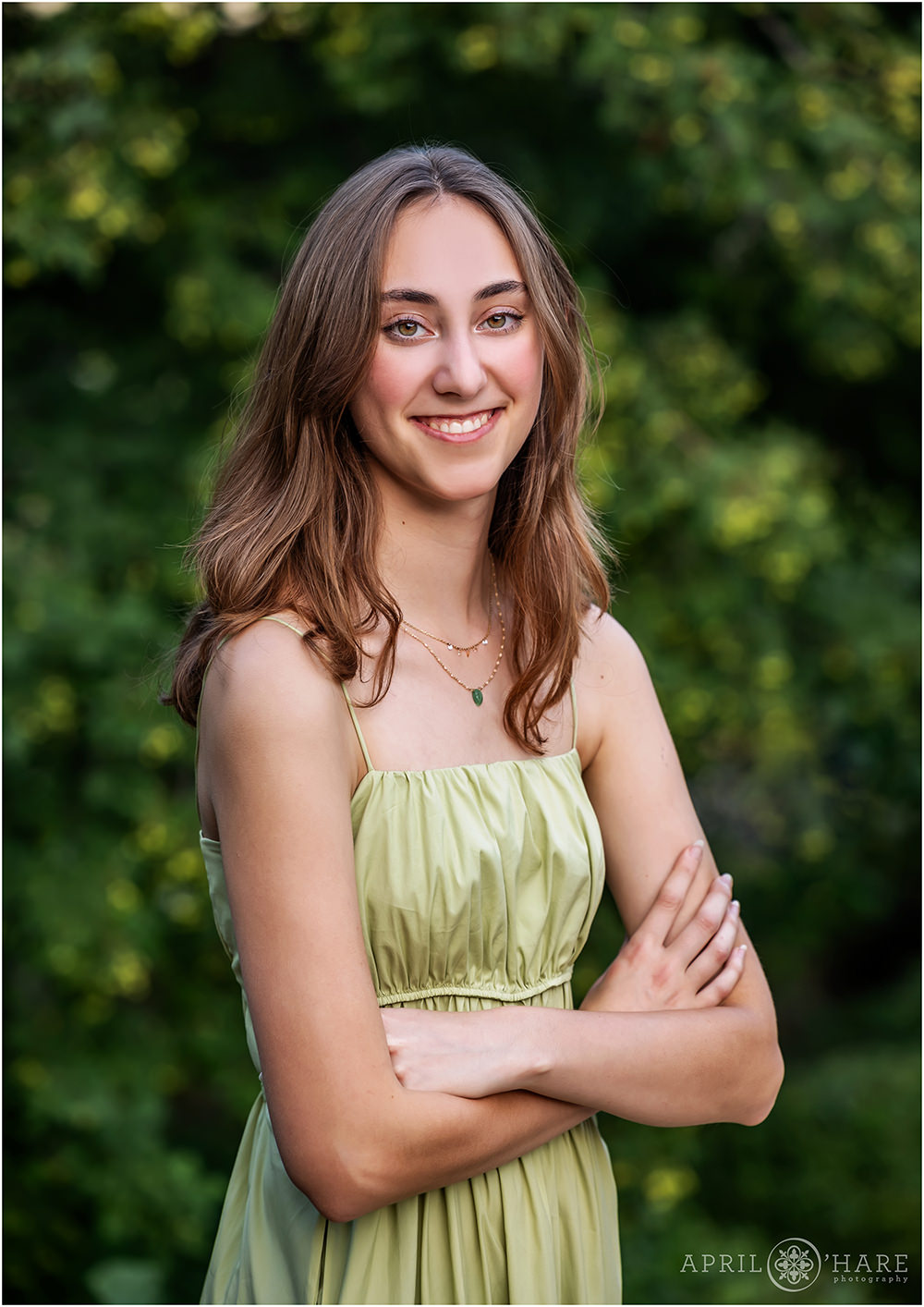 Simple green backdrop for a high school senior girl yearbook photo in Denver CO