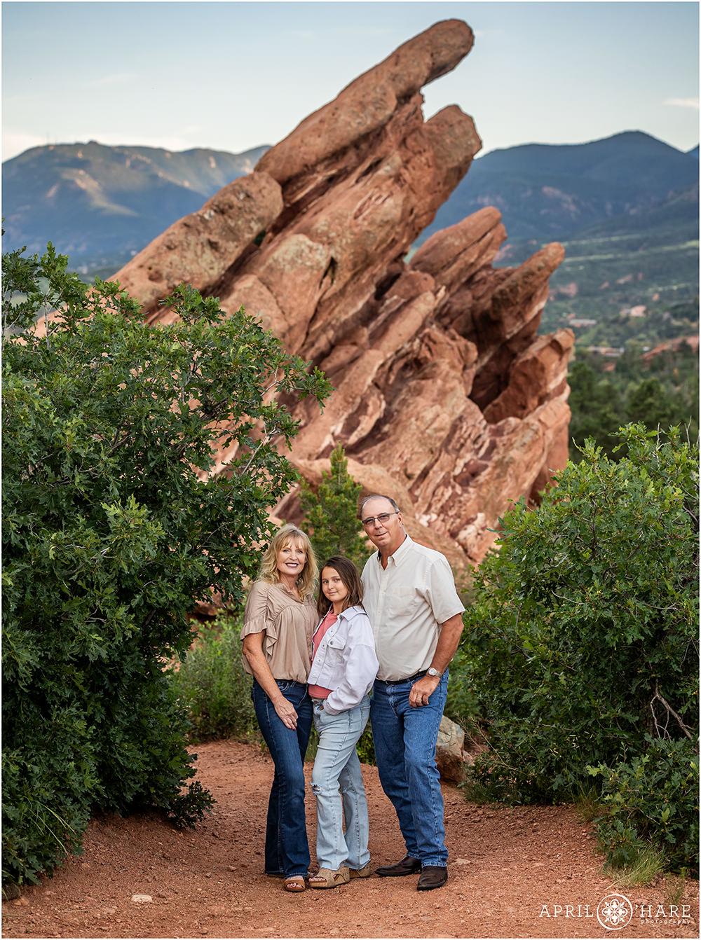 Beautiful family portrait in front of a cool red rocks formation at Garden of the Gods during summer in Colorado
