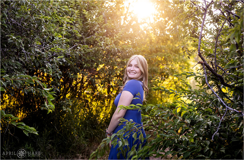 Girl with backlit tree backdrop at a trail in Parker Colorado